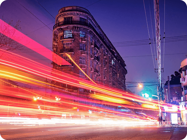 City lights blur from moving vehicles at night